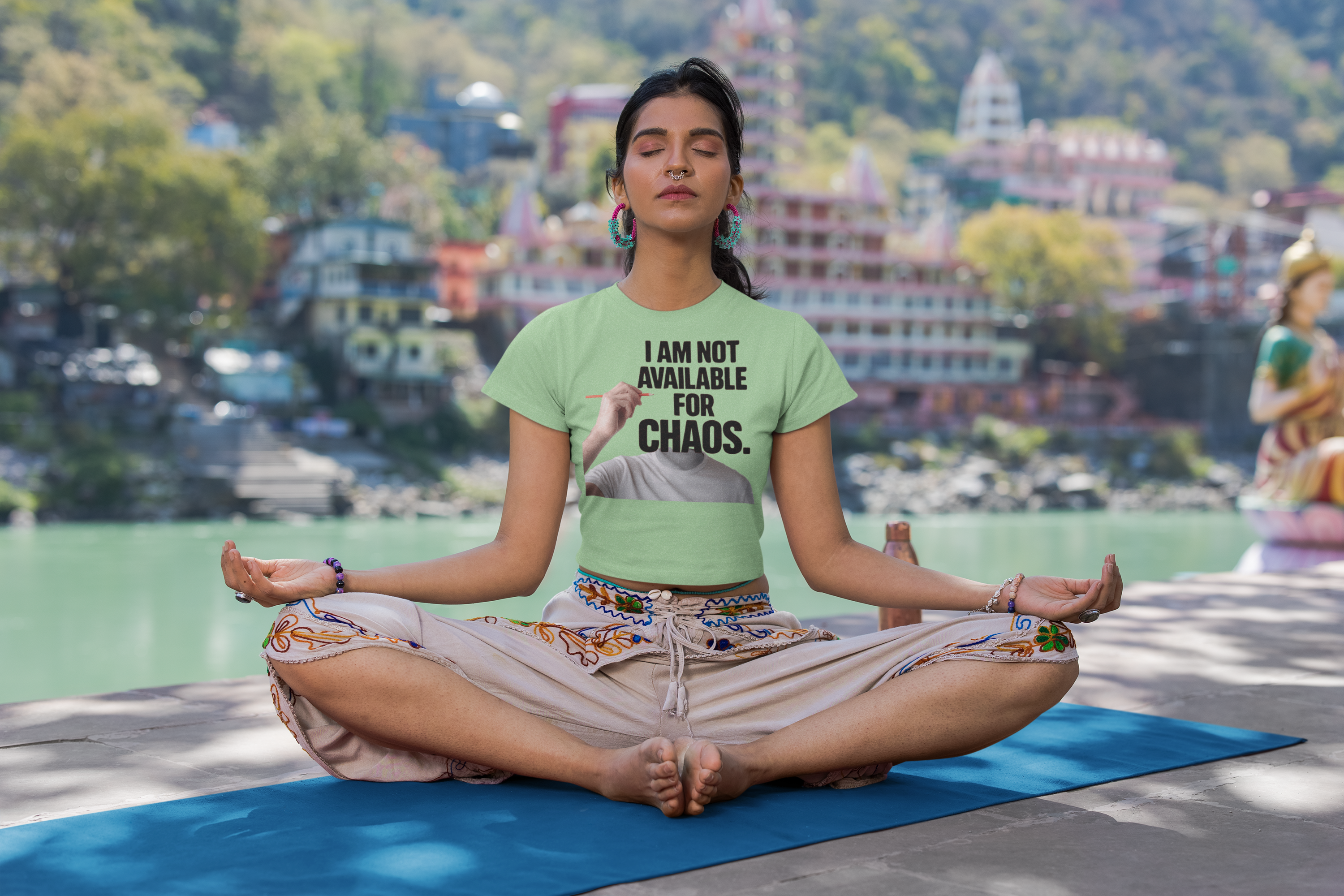 crop-top-mockup-of-a-calm-woman-meditating-near-a-lake-m33672.png