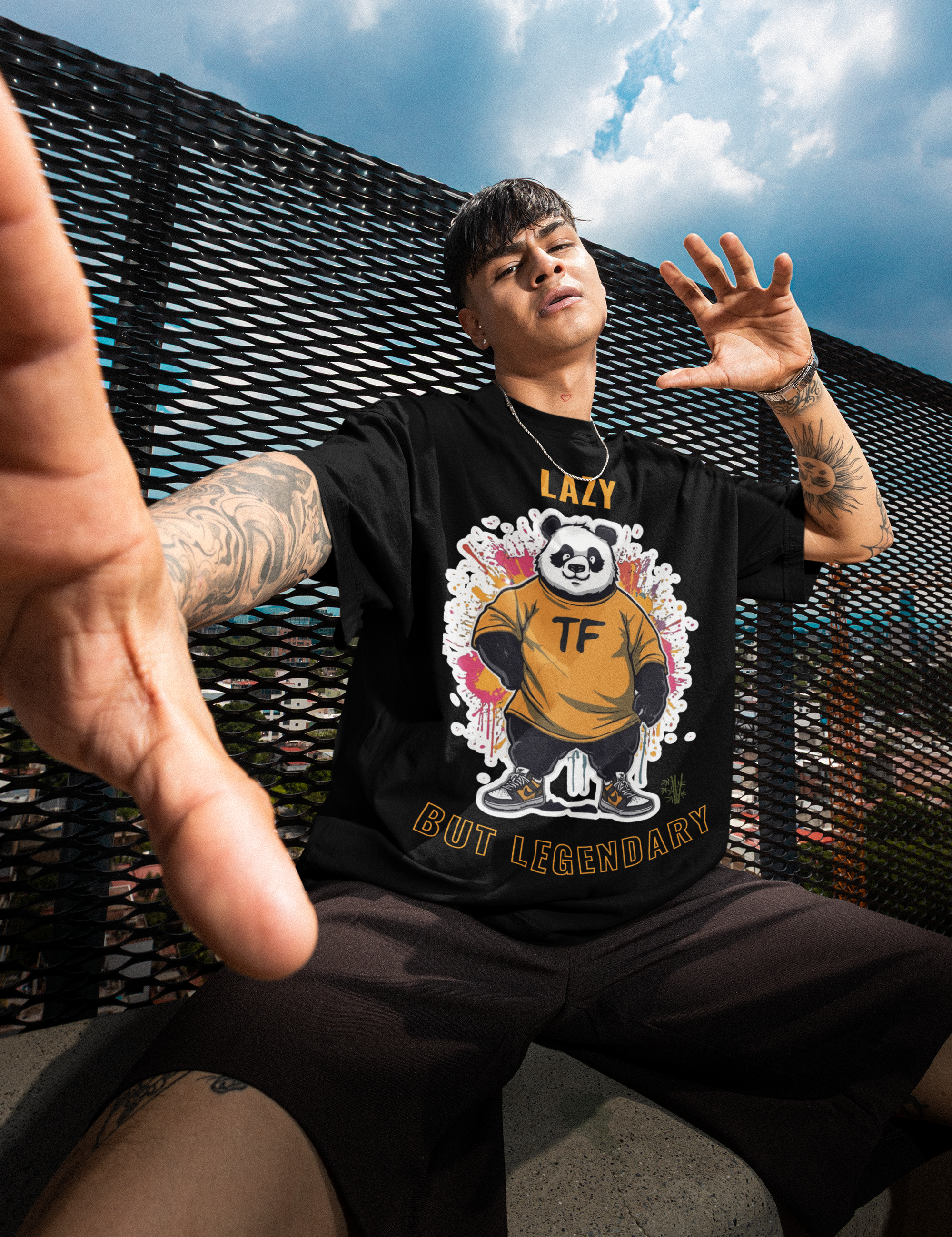 oversized-t-shirt-mockup-featuring-a-man-with-tattoos-posing-on-a-roof-m57620.png